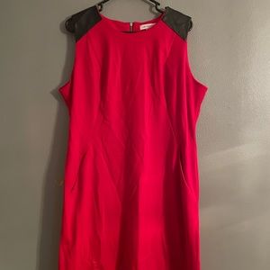 Red with leather arm details and a gold zipper.